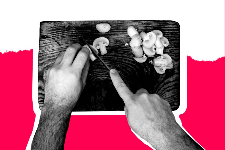 Hands chop mushrooms on a wood cutting board.